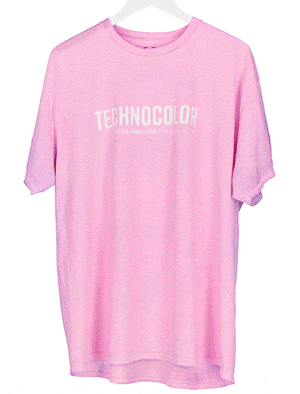 The BondiSandsEU Technocolor Technoverse Tee is a pink, heat-reactive shirt with "TECHNOCOLOR" in bold white uppercase letters across the chest, displayed on a white hanger.