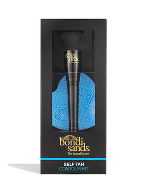 The BondiSandsEU Self Tan Contour Kit features black packaging, a contour brush with a black handle and gold logo, and a blue heart-shaped textured applicator visible through a clear window for a bronzed glow.