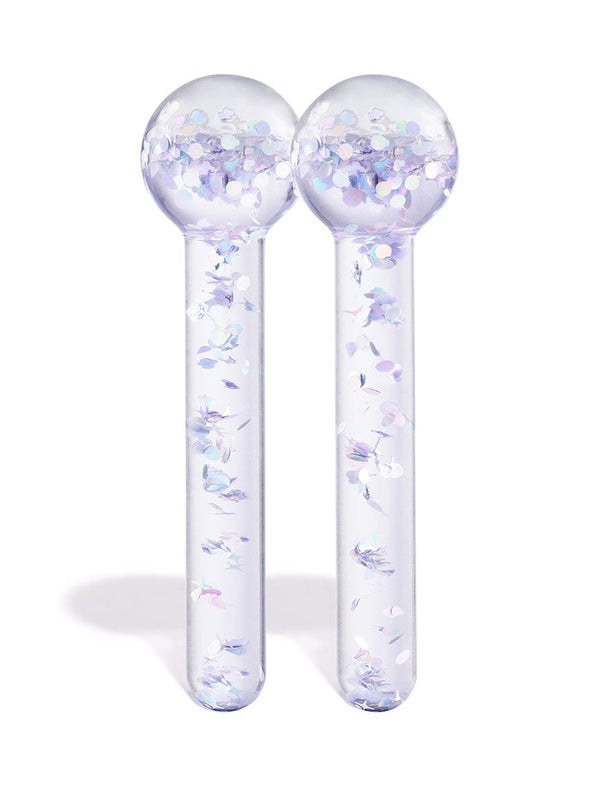 The BondiSandsEU De Puff Cooling Facial Globes—two clear glass globes with round tops and iridescent confetti—stand upright side by side against a white background, ideal for reducing puffiness and boosting lymphatic drainage.