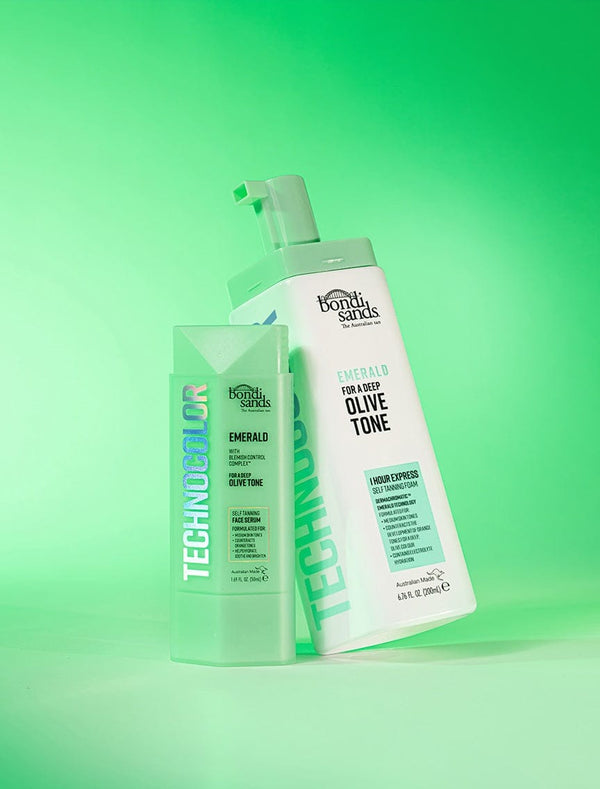 BondiSandsEU's Technocolor Emerald Self Tanning Face Serum stands upright on a green gradient background, perfect for a natural-looking tan on medium or deep olive skin.