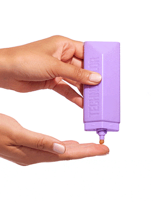 A hand squeezes the BondiSandsEU Technocolor Magenta Self Tanning Face Serum, dispensing a small amount onto the palm of another hand against a white background.