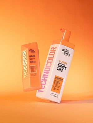 Two BondiSandsEU Technocolor Caramel Self Tanning Face Serums in orange packaging, ideal for a natural tan on deep skin tones, are shown on an orange background: one with a pump dispenser, the other in a closed rectangular tube.