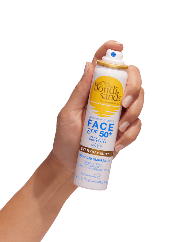A hand sprays BondiSandsEU SPF 50+ Everyday Sunscreen Face Mist, a hydrating daily sunscreen with UVA & UVB protection and a white and yellow label.
