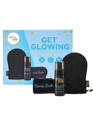 The Bondi Sands Europe Get Glowing 3 Piece Starter Kit Dark includes self tanning foam, a black application mitt, and a black headband in blue packaging, perfect for achieving a flawless bronzed glow.