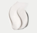 A close-up of BondiSandsEU Everyday Gradual Tanning Milk, swatched on a white background, shows its creamy texture and glossy finish that hint at rich hydration for a daily, natural-looking glow.