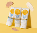 Three tubes of BondiSandsEU Face SPF 50+ Everyday Sunscreen Lotion stand upright on a yellow background with beige and pink swatches. The non-comedogenic tubes feature “Fragrance Free” and “Mattifying” in blue text.