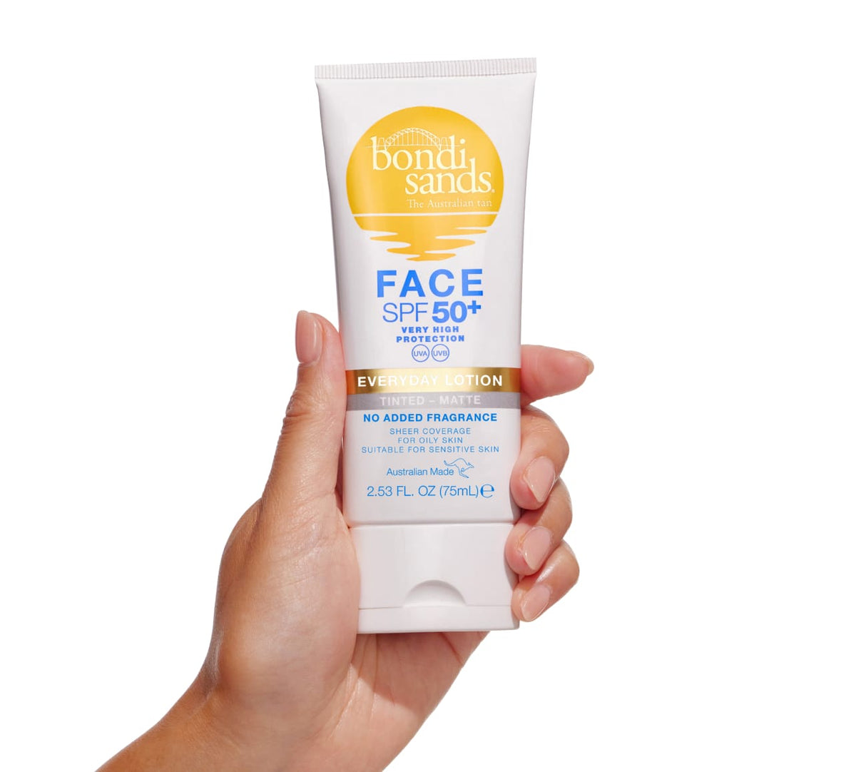 A hand holds a 2.53 fl oz (75mL) tube of BondiSandsEU SPF 50+ Everyday Matte Tinted Face Lotion, labeled as matte, fragrance-free, and suitable for sensitive or oily skin.