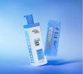Two BondiSandsEU Sapphire Technocolor Self Tanning Face Serums for natural cool-toned fair skin stand against a blue gradient background, one upright and one tilted—ideal for those seeking a natural-looking face tan.