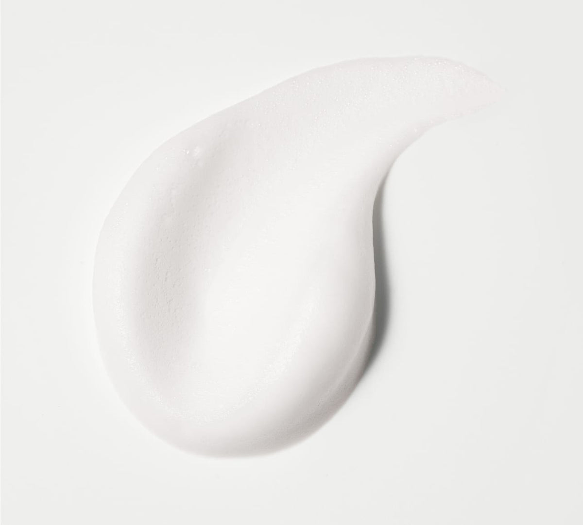A smooth, white creamy swirl of BondiSandsEU Self Tan Remover Foam Eraser Mini sits against a white background, resembling a dollop perfect for your skincare routine.