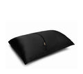 The BondiSandsEU Self Tanning Pillow Protector, in black with a smooth satin-like finish and side fabric tag, is designed to prevent tan transfer and mess-free tanning, shown against a plain white background.