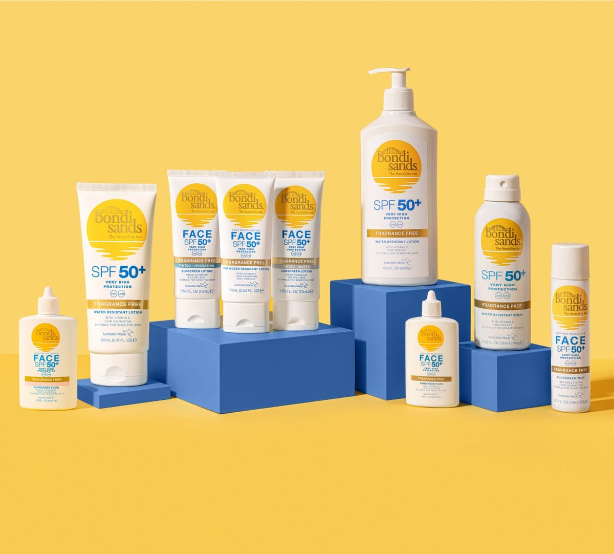 The BondiSandsEU SPF 50+ Everyday Sunscreen Face Mist is shown on blue blocks against a yellow background. This fast-absorbing face mist offers UVA and UVB protection in an easy-to-use spray container.