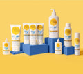 The BondiSandsEU SPF 50+ Everyday Sunscreen Face Mist is shown on blue blocks against a yellow background. This fast-absorbing face mist offers UVA and UVB protection in an easy-to-use spray container.