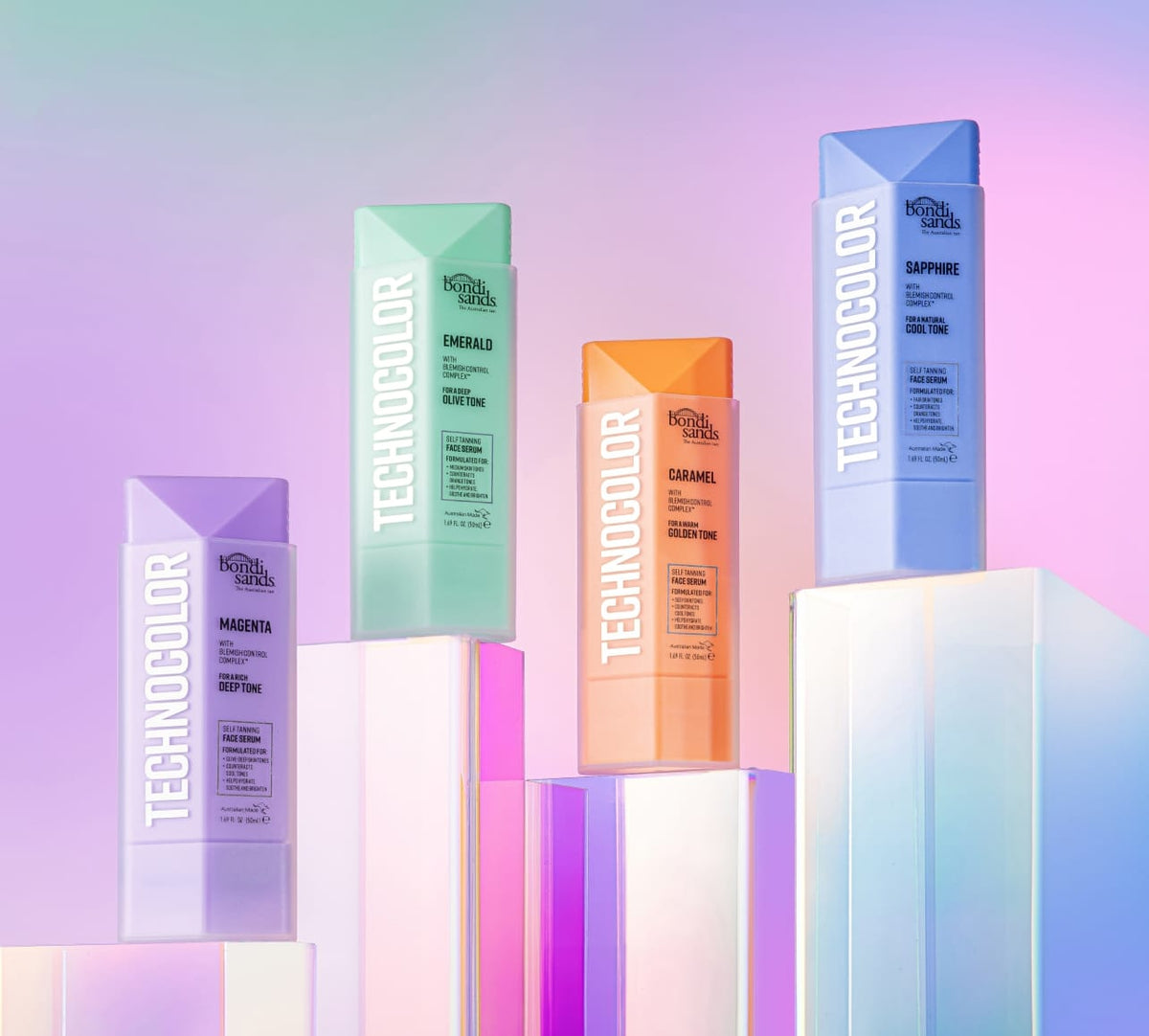 Four bright L'Oréal Professionnel Technicolor bottles—Magenta, Emerald, Caramel, Sapphire—stand on pastel blocks beside BondiSandsEU's Emerald Technocolor Self Tanning Face Serum against a soft gradient backdrop.