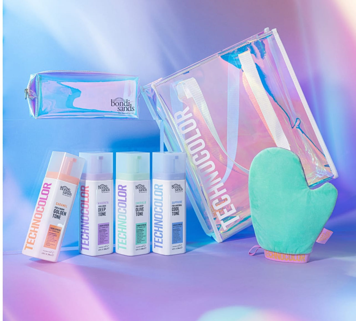 BondiSandsEU Technocolor Tote Bag set features four self-tanning bottles, a mint green mitt, limited edition tote bag, and holographic pouch, displayed against a pastel iridescent background.