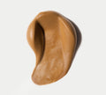 A smooth, light brown, creamy substance—like the BondiSandsEU Express Aero Self Tanning Mousse—swirls on a white background, evoking the deep bronze glow and fast-drying finish of a premium self tanner.