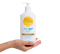 A hand holds a BondiSandsEU SPF 50+ Everyday Sunscreen Lotion Pump with blue text and a yellow sun logo on the white bottle, standing upright against a clean white background.