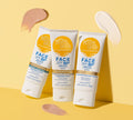 Three BondiSandsEU SPF 50+ Everyday Hydrating Tinted Face Lotion tubes—hydrating, tinted, and fragrance-free—are shown on a yellow surface with beige and pink swatches arranged around them.