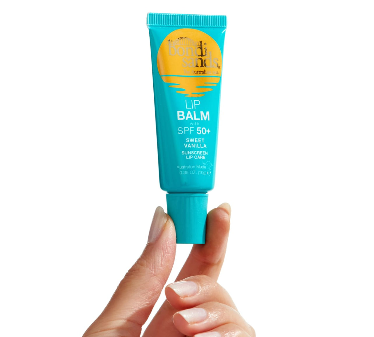 A hand holds a turquoise tube from the Bondi Sands Europe SPF Besties Bundle against a white background, with yellow and white text highlighting its SPF 50+ protection and lip care benefits for sensitive skin.