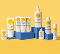 BondiSandsEU Face SPF 50+ Everyday Sunscreen Fluid is displayed on blue blocks against a yellow background, highlighting its lightweight, non-greasy formula and convenient pump bottle design.