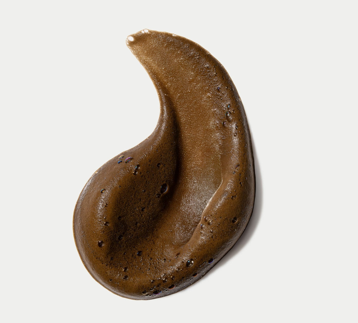 A smooth, glossy, brown gel or cream smear shaped like a teardrop, echoing the rich tones of BondiSandsEU Express Self Tanning Bundle, displayed against a white background.
