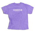 The BondiSandsEU Technocolor Technoverse Tee is an oversized purple shirt featuring "TECHNOCOLOR" and "OFFICIAL WORLD TOUR APRIL 2023" in white on the front, displayed flat against a white background.
