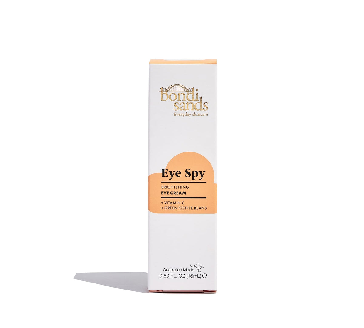 A white and orange box of BondiSandsEU Eye Spy Vitamin C Eye Cream stands upright on a white background. Formulated with vitamin C and green coffee beans, it brightens under eyes and helps reduce dark circles.
