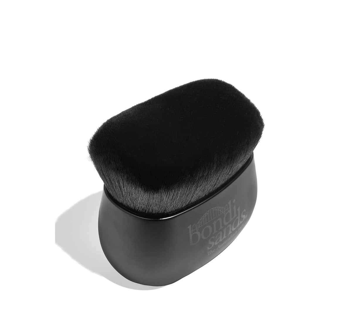 The BondiSandsEU Body Brush is a black, oval self-tanning applicator with soft bristles and the brand logo on the side, designed for a streak-free glow. It’s pictured against a white background.