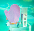 A purple tanning mitt and a bottle of BondiSandsEU Emerald Technocolor 1 Hour Express Self Tanning Foam for medium skin tones are shown on clear acrylic stands against a turquoise, water-inspired background.