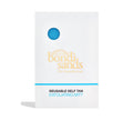 A white packet with a blue circle cutout displays the textured BondiSandsEU Exfoliation Mitt inside. The packaging features “BondiSandsEU” and “Exfoliation Mitt” in blue and gold text for a flawless, streak-free tan.