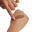 A hand applies BondiSandsEU Tinted Skin Perfector Gradual Tanning Lotion to the back of another hand with a finger against a white background for naturally glowing skin.