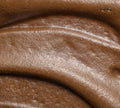 Close-up of BondiSandsEU Ultra Dark Aero Self Tanning Mousse with a smooth, creamy, glossy texture and swirled surface, reminiscent of decadent chocolate mousse.