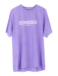 The BondiSandsEU Technocolor Technoverse Tee is an oversized purple shirt with bold white "TECHNOCOLOR" text and "OFFICIAL WORLD TOUR APRIL 2023" in smaller print, shown against a plain background.