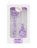 Two clear, round-ended De Puff Cooling Facial Globes by BondiSandsEU, filled with purple glitter confetti, come in a white and purple box—ideal for de-puffing and boosting lymphatic drainage.
