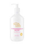 A white bottle of BondiSandsEU Tropical Rum Body Wash with a pump dispenser, featuring gold and pink text. The label notes it is pH balancing, self tan friendly, has a tropical rum scent, and contains 16.9 fl oz (500 mL).