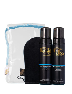The BondiSandsEU Dark Foam Gift Set includes two Dark Self Tanning Foams, an Application Mitt, and a blue-trimmed clear pouch. Achieve a flawless tan with the signature coconut scent.