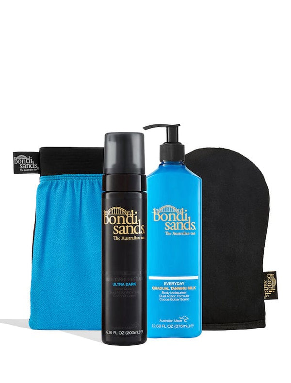 The BondiSandsEU Ultra Dark Self Tanning Routine Bundle includes an upright blue applicator pouch, black self tanning foam bottle, blue gradual tanning milk pump bottle, and a self tan application mitt.