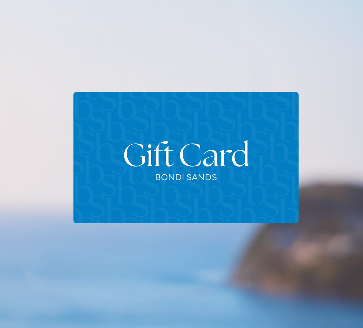 A blue BondiSandsEU Gift Card with white text appears against a blurred ocean and coastline background, ideal for email delivery.