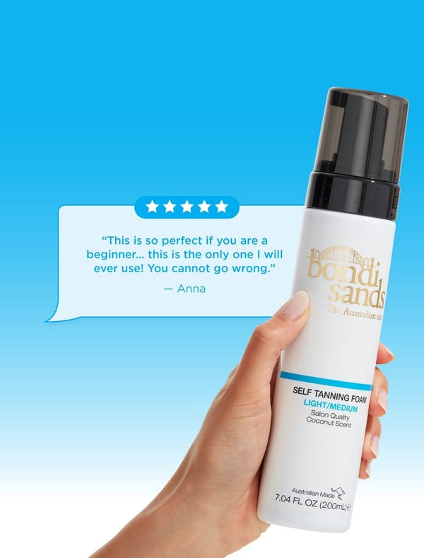 A hand holds a bottle of BondiSandsEU Self Tanning Foam Light Medium (200ml) against a blue background, with a 5-star review praising this Australian self-tanner as perfect for beginners.