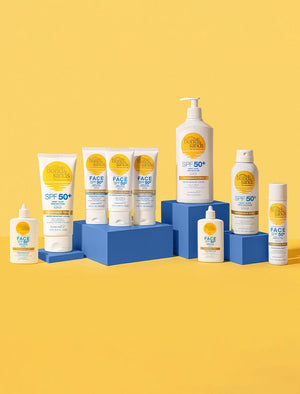 BondiSandsEU SPF 50+ Fragrance Free Hydrating Tinted Face Lotion, in a white tube with yellow and blue accents, is displayed on blue blocks against a yellow background.