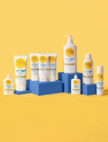 A lineup of BondiSandsEU Face SPF 50+ Tinted & Matte Sunscreen Lotion, featuring yellow and white packaging, is arranged on blue blocks against a yellow backdrop. The bottles highlight SPF 50+, ideal for oily skin protection.