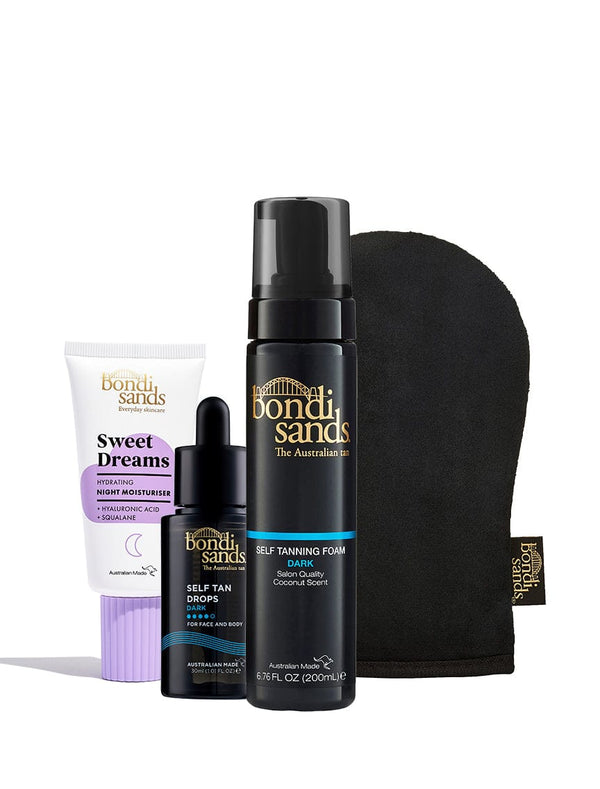 The BondiSandsEU Glow Head to Toe Bundle features Sweet Dreams night moisturiser, self tan drops, dark self tanning foam, and a black tanning mitt, all arranged upright against a white background.