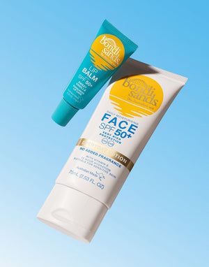 Two BondiSandsEU sunscreen products on a blue background: a hydrating SPF 50+ Lip Balm Sweet Vanilla tube and a white tube of face sunscreen labeled Face SPF 50+ Daily Moisturising.