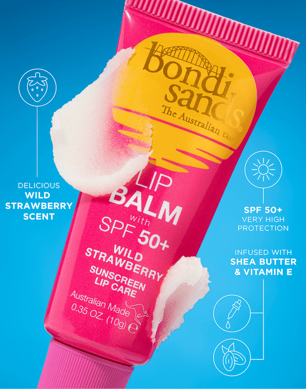 A pink tube of BondiSandsEU SPF 50+ Lip Balm Wild Strawberry with nourishing Shea Butter sits on a blue background amid white balm smears, with scent, SPF 50+, and ingredients highlighted in text.