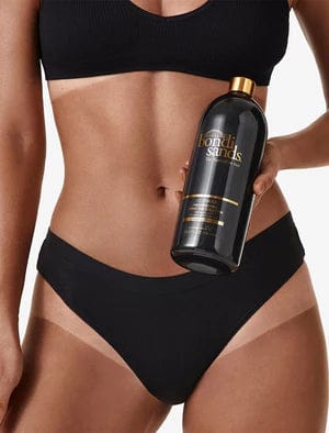 Bondi Sands Salon Solution Liquid Gold Model Holding Bottle