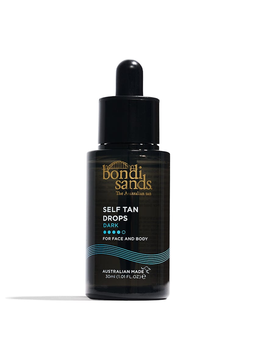 BondiSandsEU Dark Self Tanning Face Drops come in a bottle with a black dropper cap and gold and white text on a black background. These non-comedogenic drops are suitable for sensitive skin and labeled for face and body use.