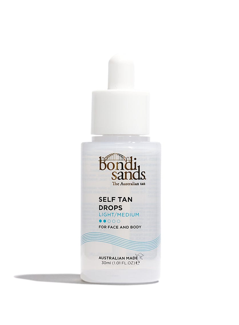 A clear BondiSandsEU Light/Medium Self Tanning Face Drops bottle with a white dropper cap and blue-gold text stands upright on a white background. Designed for face tanning, it offers a light, customisable glow and is non-comedogenic.