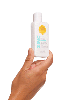 A hand holds a white bottle of BondiSandsEU SPF 50+ Mineral Face Fluid against a plain white background. The label, featuring yellow and blue text, showcases invisible and powerful sun protection for your skin.